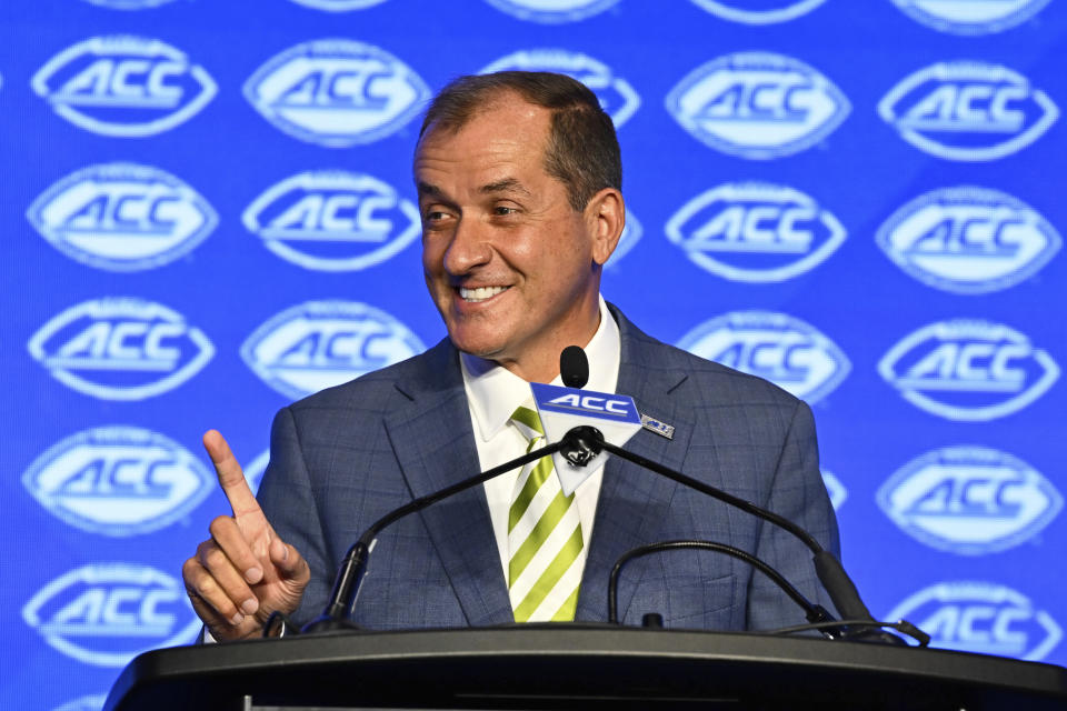 ACC Commissioner Jim Phillips smiles during a college football news conference Monday.  (AP Photo/Matt Kelley)